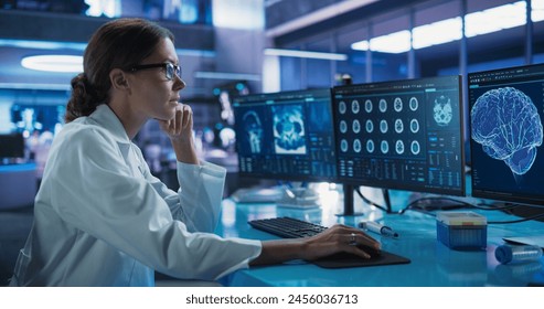 Hospital Research Laboratory: Female Medical Scientist Using Computer with Brain Scan MRI Images. Professional Neurologist Analysing CT Scan, Finding Treatment Solutions for Patient With Alzheimer's. - Powered by Shutterstock