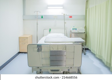 A hospital room with bed and chair