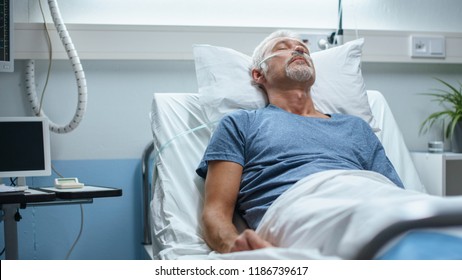 In The Hospital, Senior Patient Lying In Bed, Sleeping. Modern Hospital Geriatrics Ward.