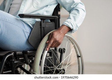 Hospital for service patient and disabled people. Medical equipment in clinic for assistance handicapped people. African american man in chair with wheels for patient care at home, focus on hand - Shutterstock ID 1970646290