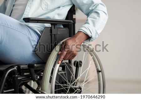 Hospital for service patient and disabled people. Medical equipment in clinic for assistance handicapped people. African american man in chair with wheels for patient care at home, focus on hand