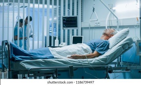 In the Hospital Sick Man Rests, Lying on the Bed. Recovering Man Sleeping in the Modern Hospital Ward. - Powered by Shutterstock