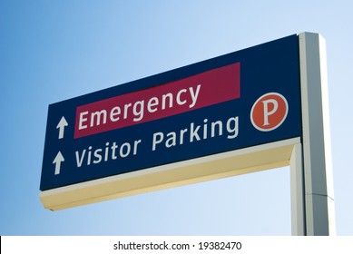 Hospital Sign Showing The Way To The Emergency Entrance And Visitor Parking.