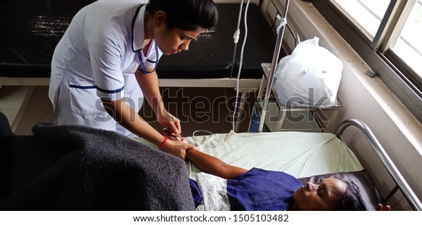 hospital staff plugin needle into lady patient hand\
during treatment at district Katni Madhya Pradesh in India shot\
captured on sep 2019