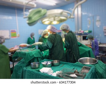 Hospital - Surgery Team In The Operating Room Or Op Of A Clinic Operating On A Patient.