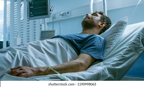 In The Hospital, Terminally Ill Man Suffers While Lying On The Bed. Young Man In Palliative Care Ward.