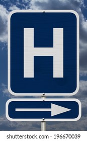Hospital this way, A blue road sign with a capital H and an arrow with sky background