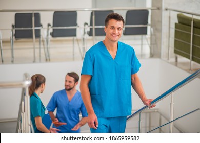 In The Hospital. Three Doctors Going Up The Stairs And Talking