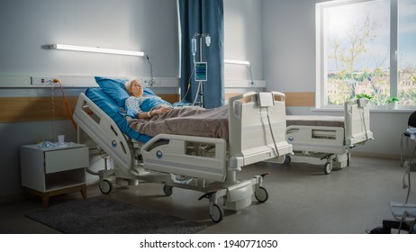 Hospital Ward: Beautiful Caucasian Female Patient Resting Peacefully In Bed, Recovering After Successful Surgery. Spaceous Light Room With Window With A Sunny View. Modern Equipment Clinic