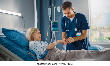 Hospital Ward: Friendly Head Nurse Connects Finger Heart Rate Monitor Pulse Oximeter to Beautiful Female Patient Resting in Bed. Nurse Does Patient Checkup After Successful Surgery. Modern Clinic - Powered by Shutterstock