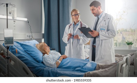 Hospital Ward: Male And Feamle Professional Caucasian Doctors Talk With A Patient, Give Health Care Advice, Recommend Treatment Plan. Modern Clinic With Advanced Equipment And Best Medicare Service