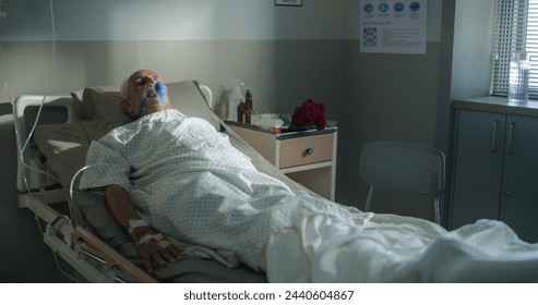 Hospital Ward: Portrait of Indian Elderly Man Wearing Oxygen Mask Sleeping in Bed, Recovering after Sickness and Successful Surgery. Senior Man Resting After Health Complication - Powered by Shutterstock