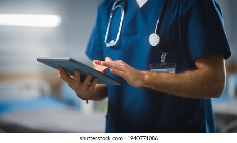 Hospital Ward: Unrecognizable Head Nurse, Doctor, Surgeon Uses Digital Tablet Computer Health Care Vitals Monitoring Computer Machine. Modern Clinic with Advanced Equipment and Professional Working - Shutterstock ID 1940771086