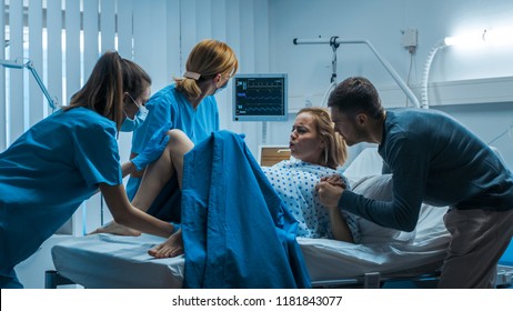 In the Hospital Woman in Labor Pushes to Give Birth, Obstetricians Assisting, Husband Holds Her Hand. Modern Delivery Ward with Professional Midwives. - Shutterstock ID 1181843077