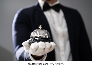Hospitality Service Concierge In Uniforms With Butler Bell In Hand