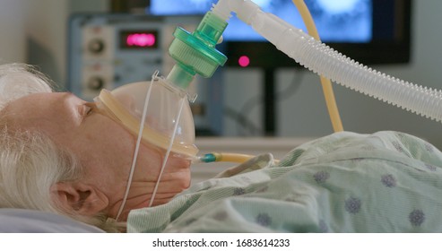 A hospitalized elderly woman attached to a device to help her breathe with an image of the coronavirus in the background.
