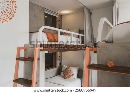 Hostel dormitory beds arranged in dorm room with white bunk bed in dormitory