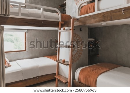 Hostel dormitory beds arranged in dorm room with white bunk bed in dormitory