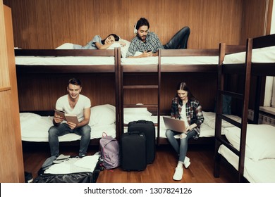 Hostel for Young People. Best Friends Traveling. Small Room in Hostel. spend time Together. bunk beds in room. smiling People. Communicate. sit and lie on bed. Rest. work. read. listen to music