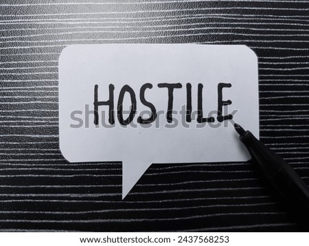 Hostile writting on table background.