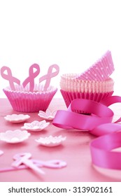 Hosting An Event For Pink Ribbon Day, Breast Cancer Awareness Fundraising, With Cupcake Decorations On A Vintage Pink Wood Table. 