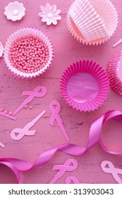 Hosting An Event For Pink Ribbon Day, Breast Cancer Awareness Fundraising, With Cupcake Decorations On A Vintage Pink Wood Table. 