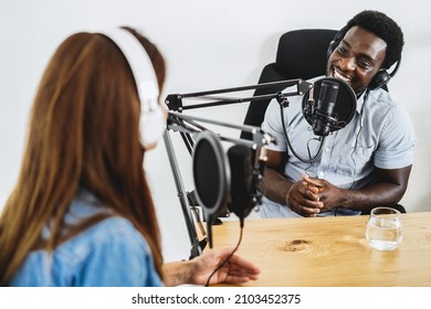 Hosts Having Podcast Session Together - African Speaker Making An Interview During Live Stream - Main Focus On Black Man Microphone