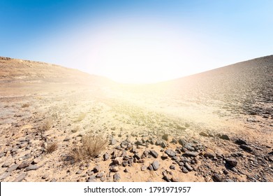 Hot afternoon sun of the Israel desert. Dusty mountains interrupted by wadis and deep craters. - Shutterstock ID 1791971957