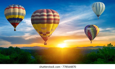 Hot air balloon above high mountain at sunset