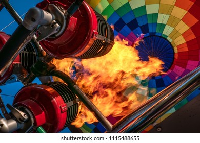 Hot air balloon or aerostat, bright burning fire flame from gas burner equipment, close up from inside 