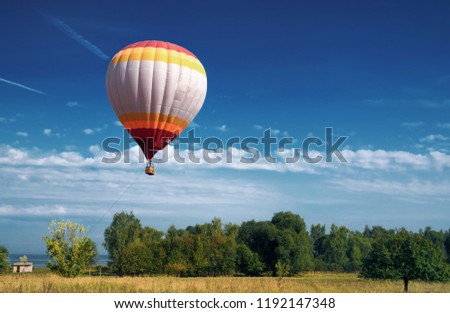 hot air balloon in blue cloudy sky