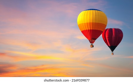 Hot air balloon floating in vivid sky with cloud painted by the sun before sunset in winter. Colorful sky on evening time. Bright blue, orange and yellow colors sunset . - Powered by Shutterstock