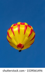Hot air balloon flying high in blue sky