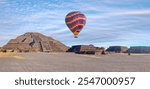 Hot air balloon flying over Teotihuacan pyramids complex located in Mexican Highlands and Mexico Valley close to Mexico City. Mexico