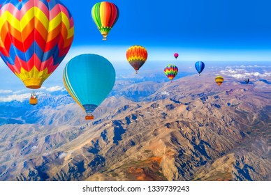Hot air balloon flying over amazing mountains