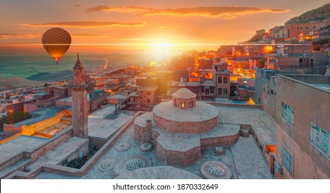 Hot air Balloon flying over Mardin old town - Mardin old town at twilight blue hour - Mardin, Turkey