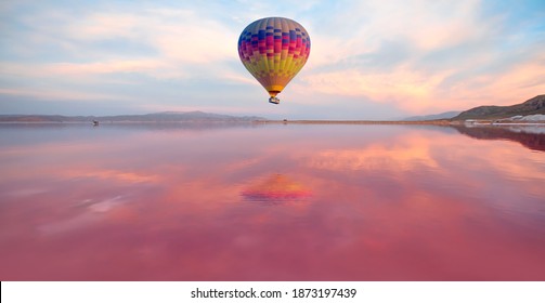 Hot air balloon flying over spectacular Maharlu pink lake at sunset - Shiraz, Iran - Powered by Shutterstock