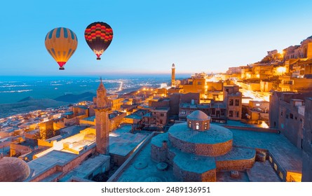 Hot air Balloon flying over Mardin old town - Mardin old town at twilight blue hour - Mardin, Turkey - Powered by Shutterstock