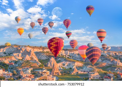 Hot air balloon flying over spectacular Cappadocia with full moon "Elements of this image furnished by NASA "