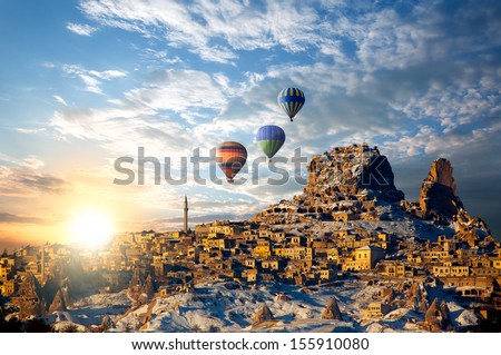 Hot air balloon flying over spectacular Cappadocia at dusk - Goreme, Turkey