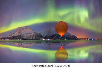 Hot air balloon flying with spectacular Northern lights - Northern lights (Aurora borealis) in the sky over Tromso, Norway