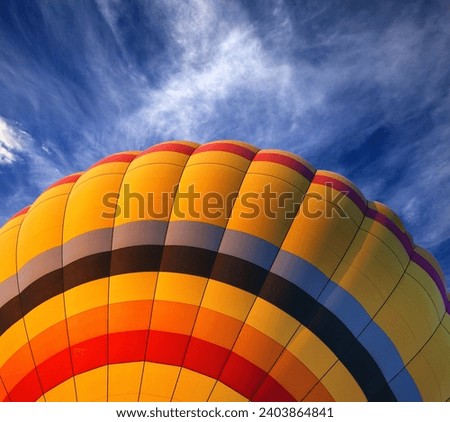 Hot air balloon on blue sky with clouds at nice sun evening. Close-up view.
