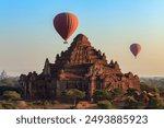 Hot air balloon over Dhammayangyi temple at sunrise,  Bagan, Myanmar