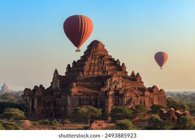 Hot air balloon over Dhammayangyi temple at sunrise,  Bagan, Myanmar - Powered by Shutterstock