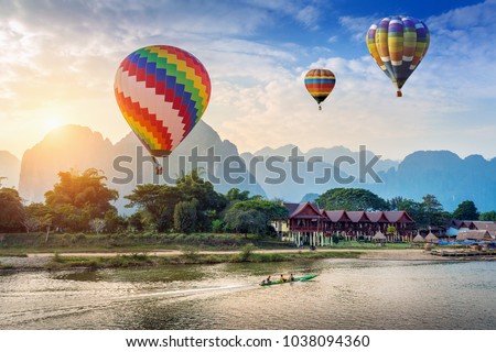 Hot air balloon over Nam Song river at sunset in Vang vieng, Laos.