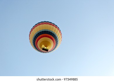 Hot air balloon over rock formations in Cappadocia, Turkey