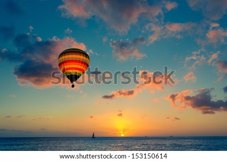 Hot air balloon over the sea at sunset