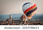 Hot air balloon rising in front of the Duomo in Florence during sunrise from Piazzale Michelangelo, Florence, Italy. Europe Travel Concept. Cityscape.