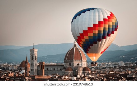 Hot air balloon rising in front of the Duomo in Florence during sunrise from Piazzale Michelangelo, Florence, Italy. Europe Travel Concept. Cityscape.