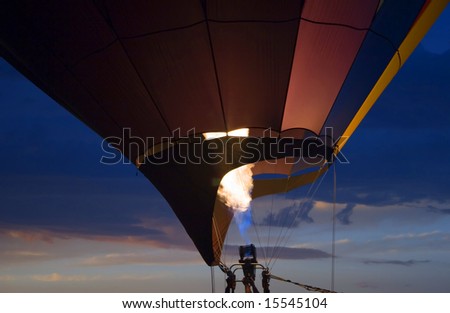 Hot air balloon taking off at sunset